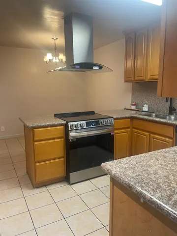 a kitchen with a stove sink and cabinets