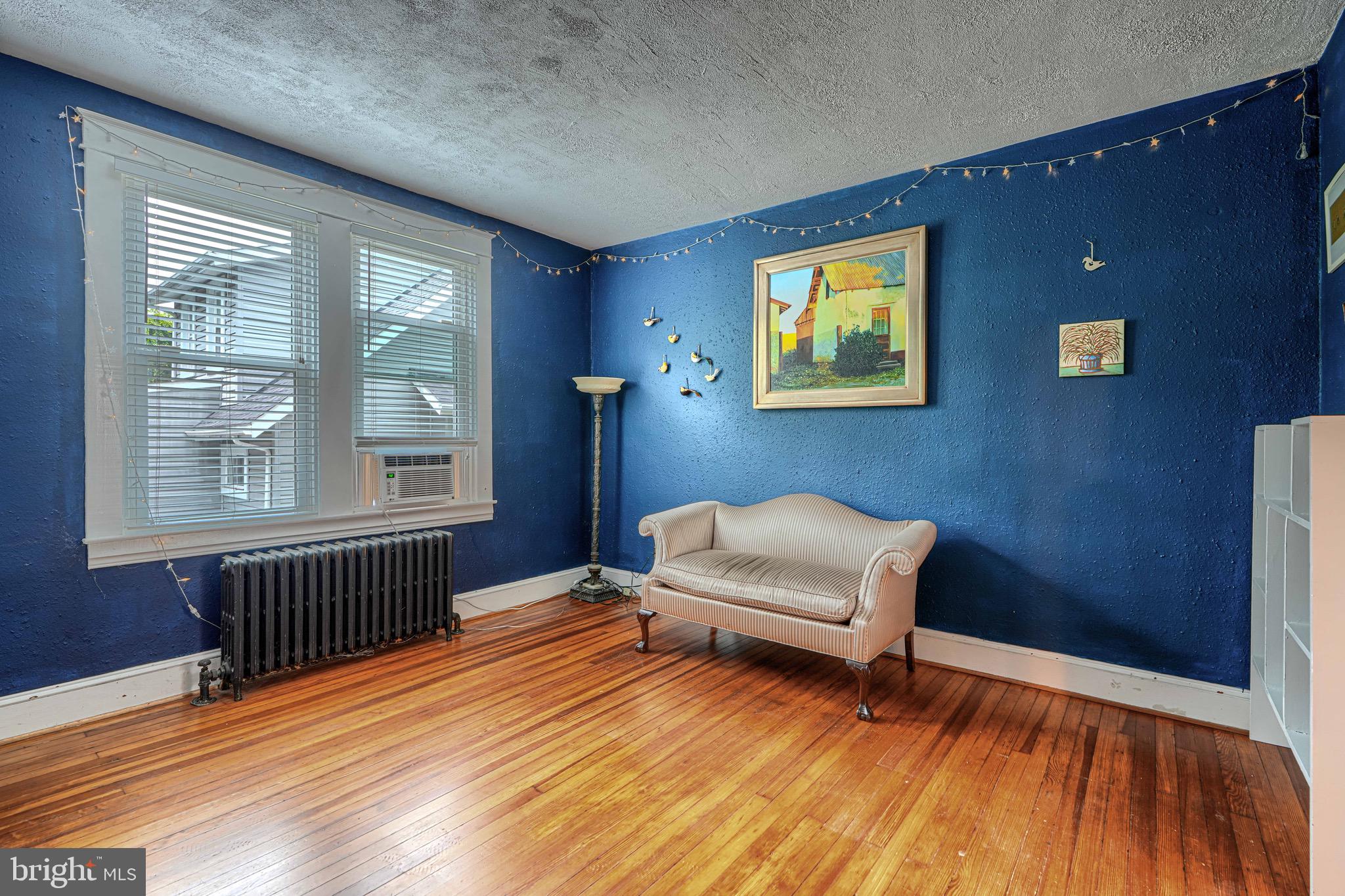 2705 Latona Road Baltimore, MD 21214 - Photo 20 of 53 a bedroom with a bed and wooden floor