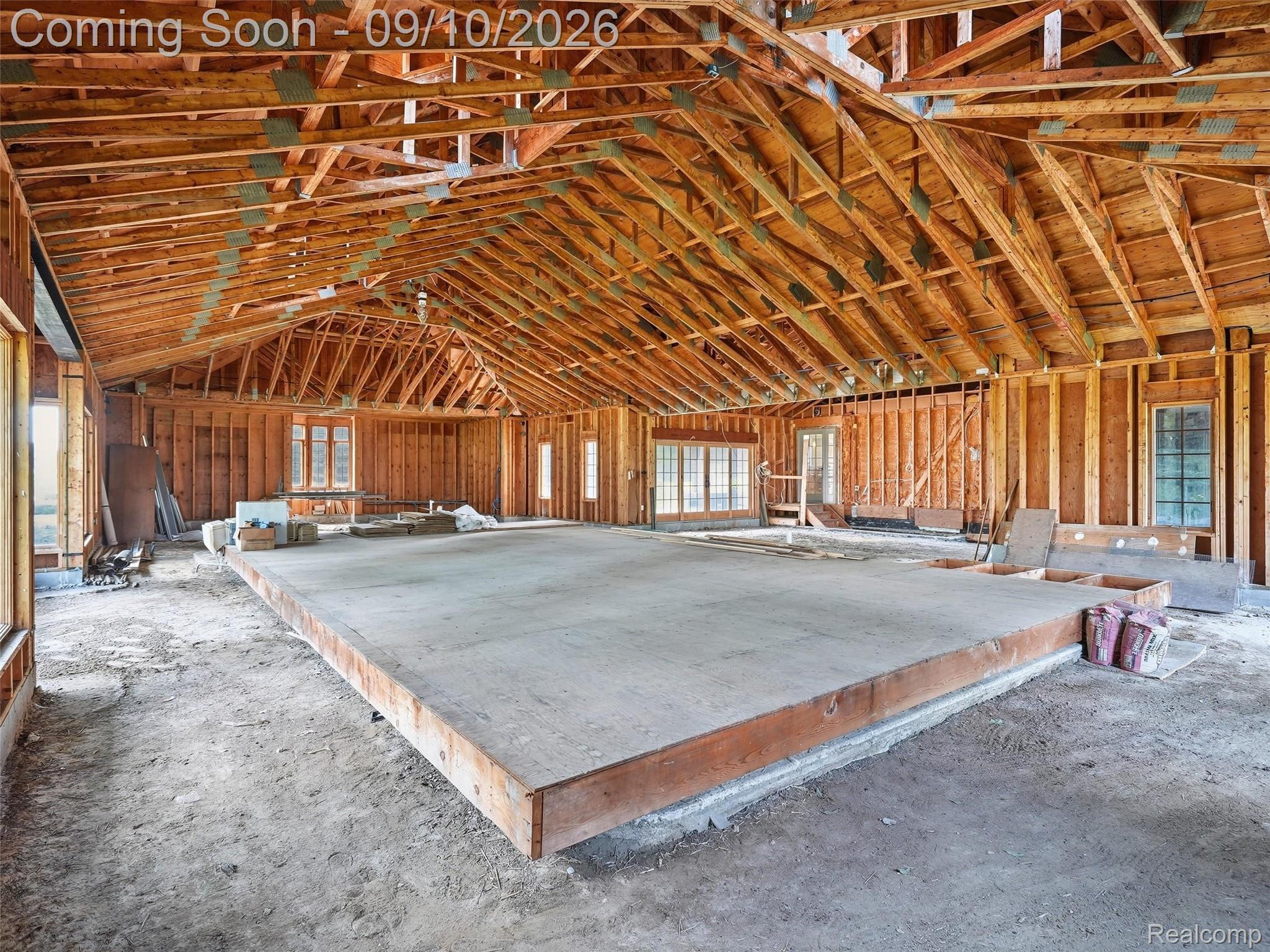 61400 Romeo Plank Road Ray, MI 48096 - Photo 50 of 99 Exposed wood framing, vaulted ceiling, multiple window openings, and a raised concrete platform
