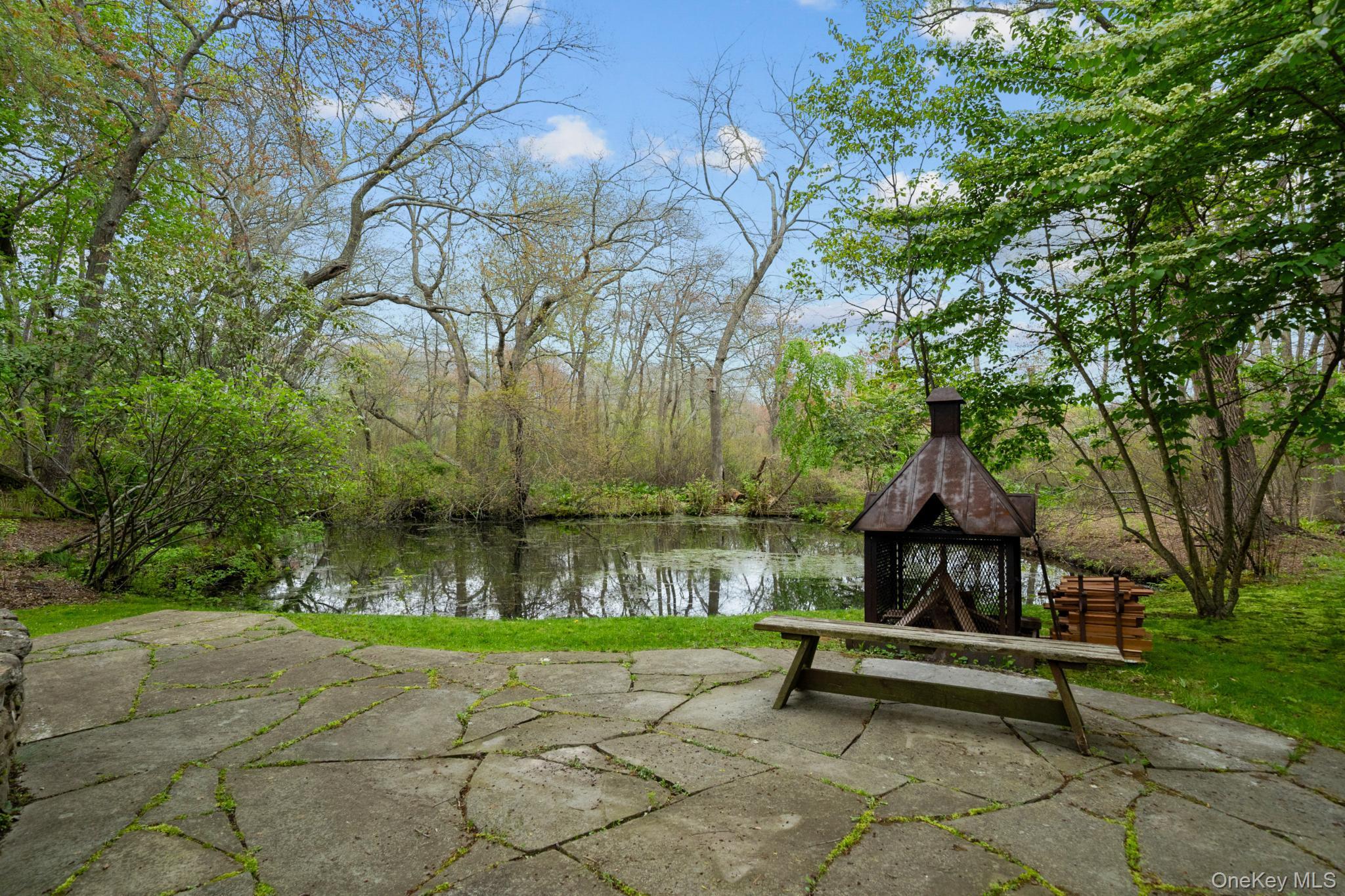 6 Prairie Lane Brookhaven, NY 11719 - Photo 24 of 31 Custom Fire pit stone patio overlooking the pond