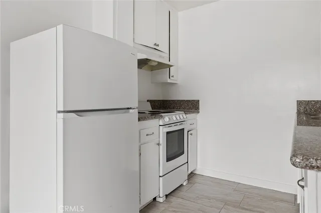 a kitchen with a stove and a refrigerator
