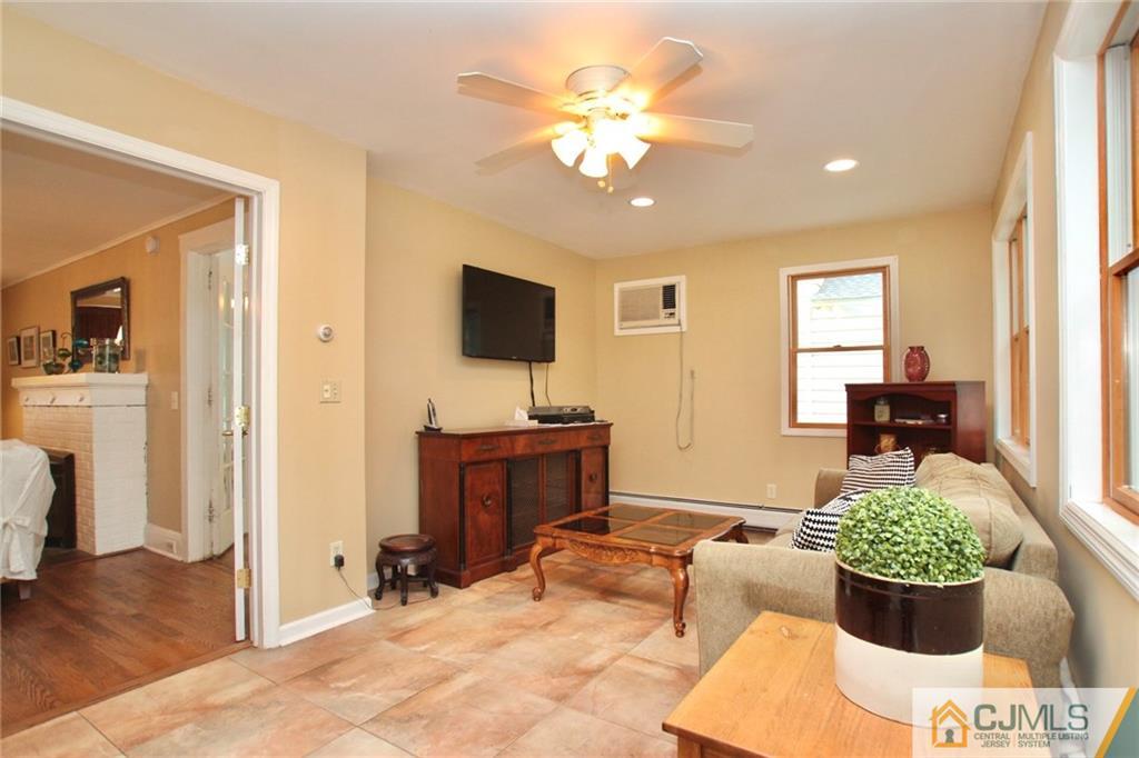 117 Russell Road Fanwood, NJ 07023 - Photo 11 of 22 a living room with furniture and a flat screen tv