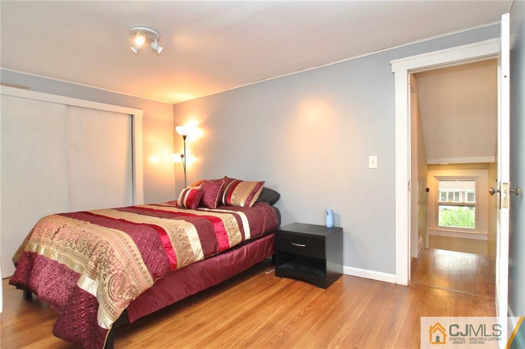 117 Russell Road Fanwood, NJ 07023 - Photo 14 of 22 a bedroom with a bed and wooden floor