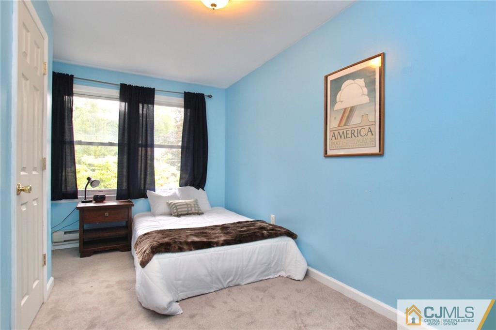117 Russell Road Fanwood, NJ 07023 - Photo 17 of 22 a bedroom with a bed and a large window
