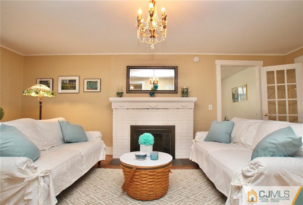 117 Russell Road Fanwood, NJ 07023 - Photo 3 of 22 a living room with furniture a fireplace and a window