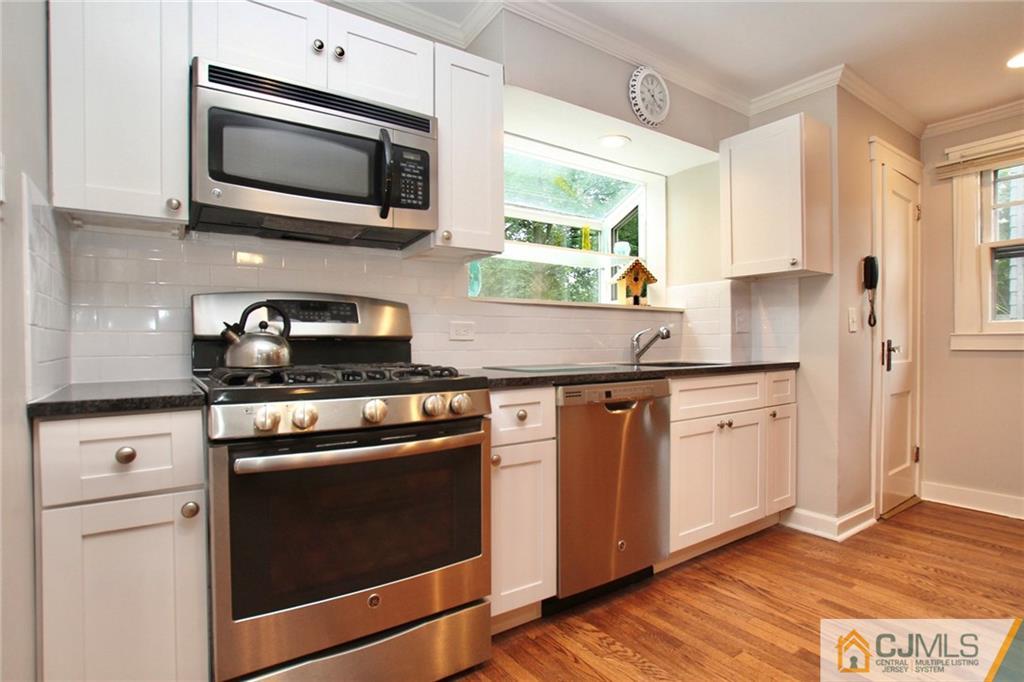 117 Russell Road Fanwood, NJ 07023 - Photo 6 of 22 a kitchen with granite countertop cabinets stainless steel appliances and wooden floor
