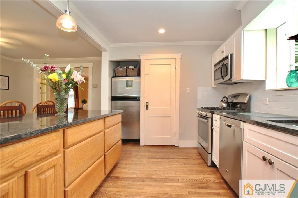 117 Russell Road Fanwood, NJ 07023 - Photo 7 of 22 a kitchen with stainless steel appliances granite countertop a sink and cabinets
