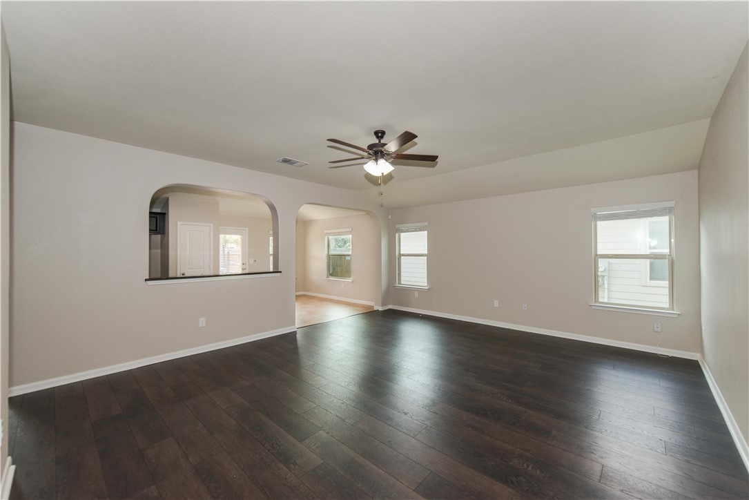 1007 Plateau Trail Georgetown, TX 78626 - Photo 3 of 32 a view of an empty room with wooden floor and a window