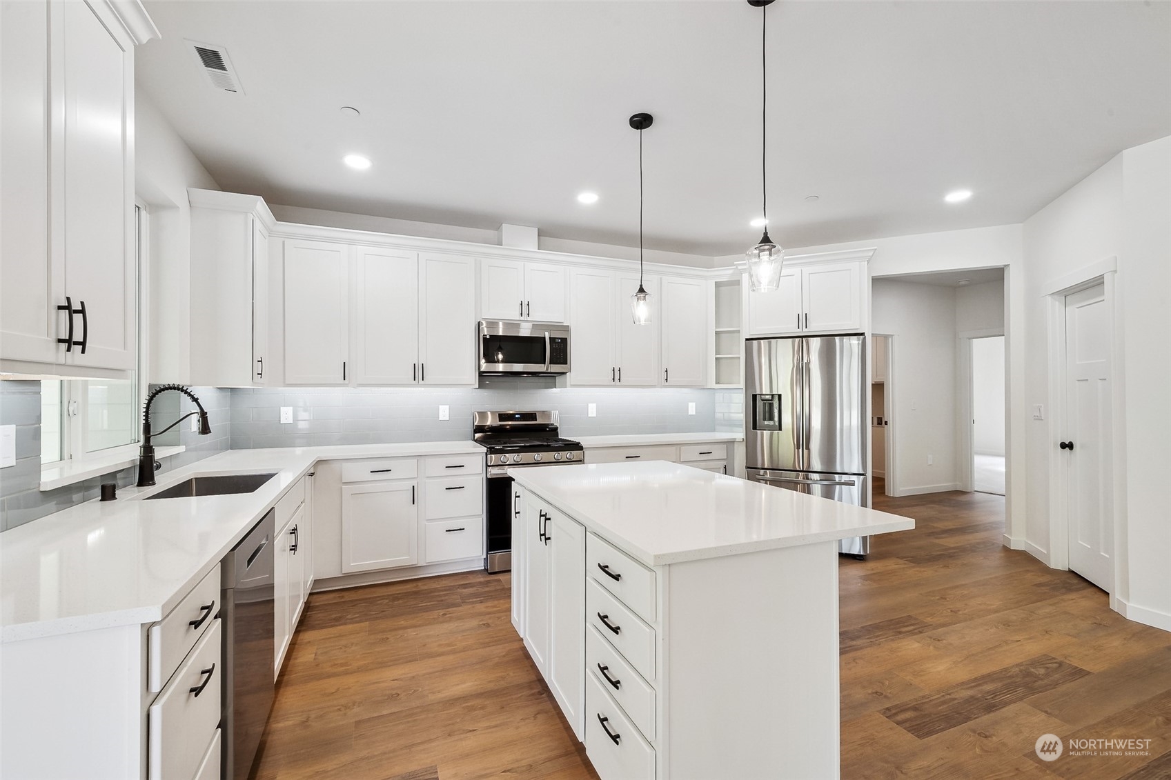 27117 Entwhistle Road East Buckley, WA 98321 - Photo 10 of 40 a large white kitchen with stainless steel appliances sink refrigerator and microwave