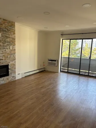 wooden floor in an empty room with a fireplace