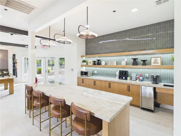a large kitchen with a table and chairs