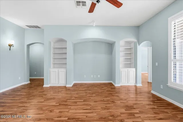 a kitchen with granite countertop white cabinets and a stove