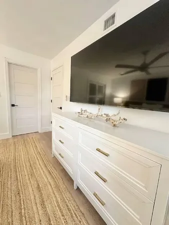 a bathroom with a double vanity sink mirror toilet shower and bathtub