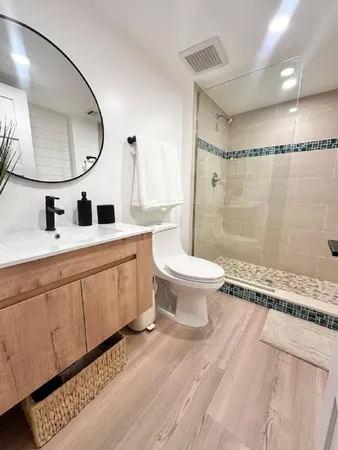 a bathroom with a toilet a sink and a mirror