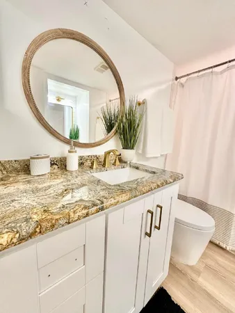 a kitchen with kitchen island granite countertop a sink and a stove