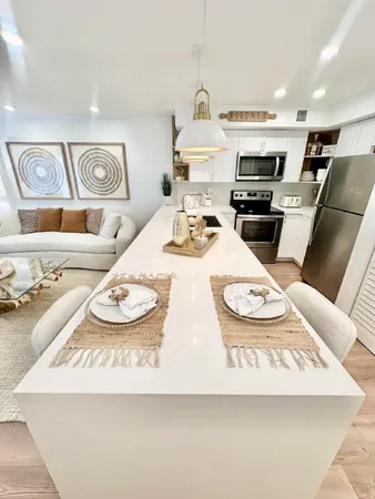 a kitchen with kitchen island a stove a sink and a refrigerator