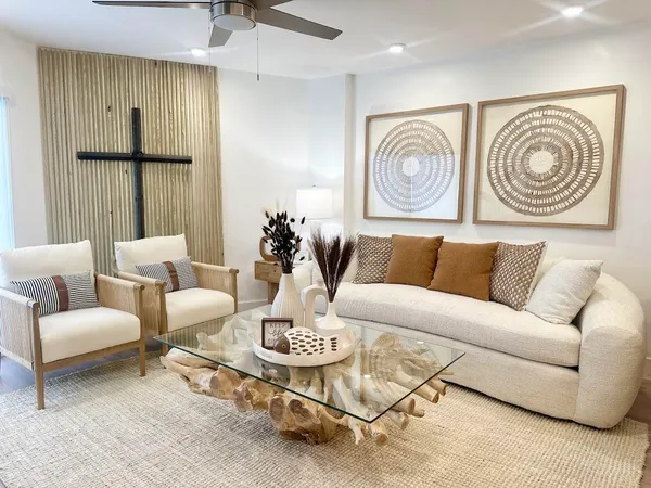 a living room with furniture and painting on the wall