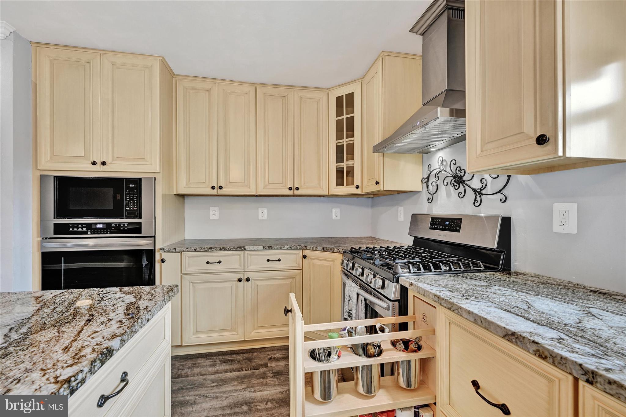 1485 Bachmans Valley Road Westminster, MD 21158 - Photo 11 of 60 a kitchen with granite countertop a stove top oven microwave and cabinets
