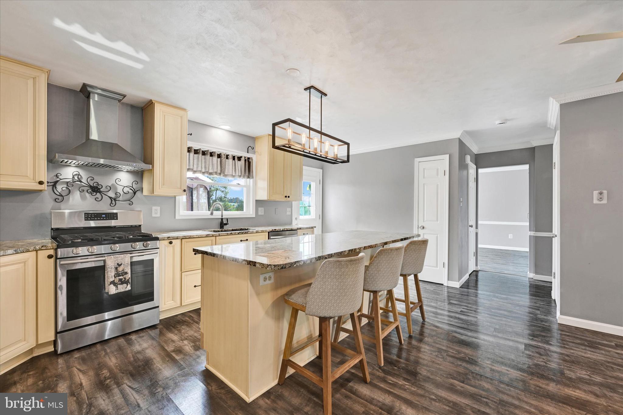 1485 Bachmans Valley Road Westminster, MD 21158 - Photo 15 of 60 a kitchen with a table chairs stove and cabinets