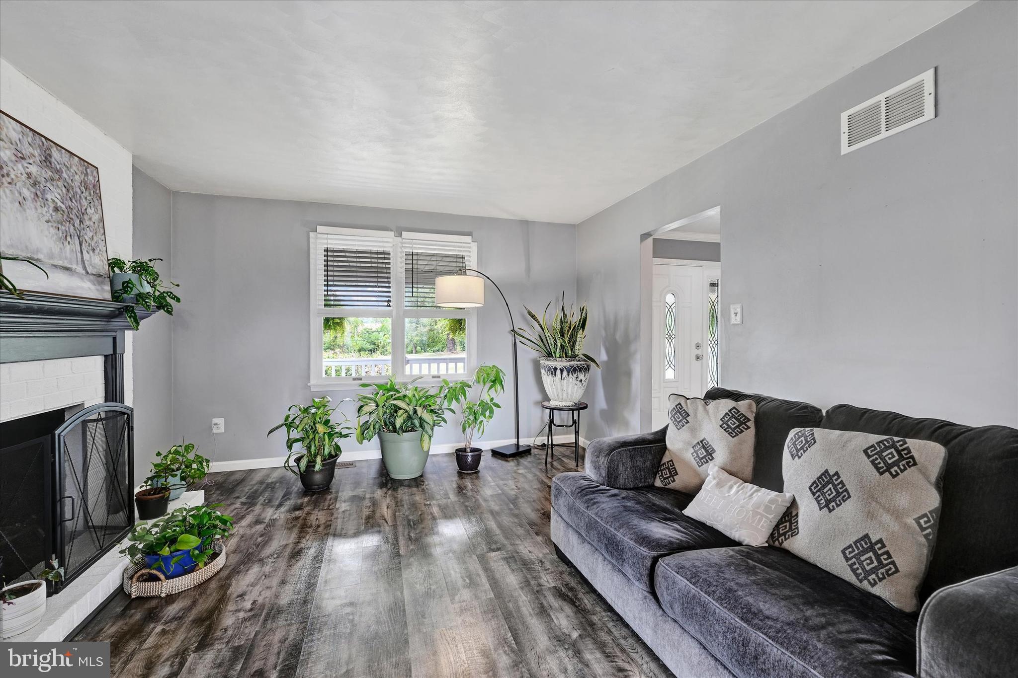 1485 Bachmans Valley Road Westminster, MD 21158 - Photo 22 of 60 a living room with furniture fireplace and potted plants