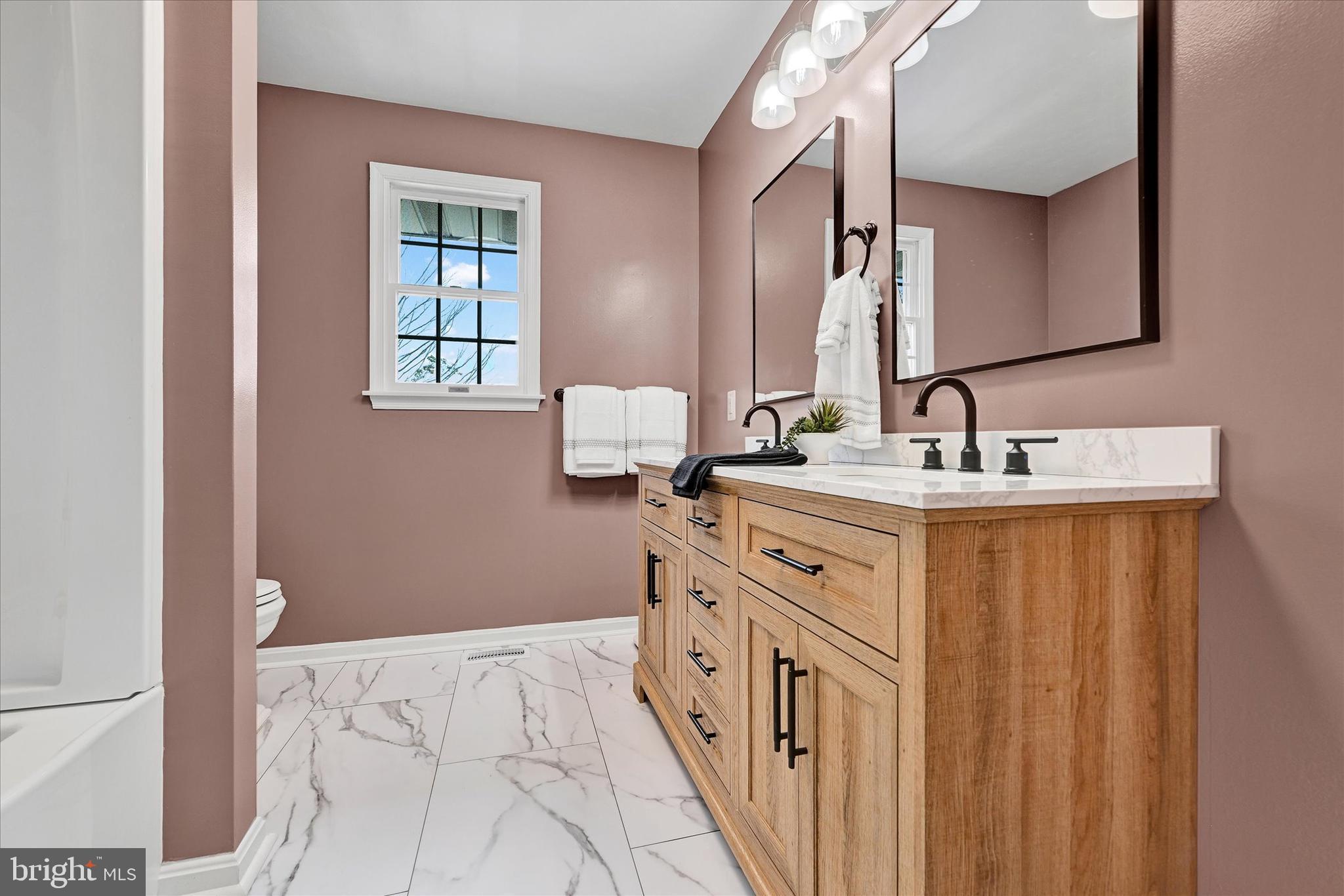 1485 Bachmans Valley Road Westminster, MD 21158 - Photo 26 of 60 a spacious bathroom with a double vanity sink a mirror and a
