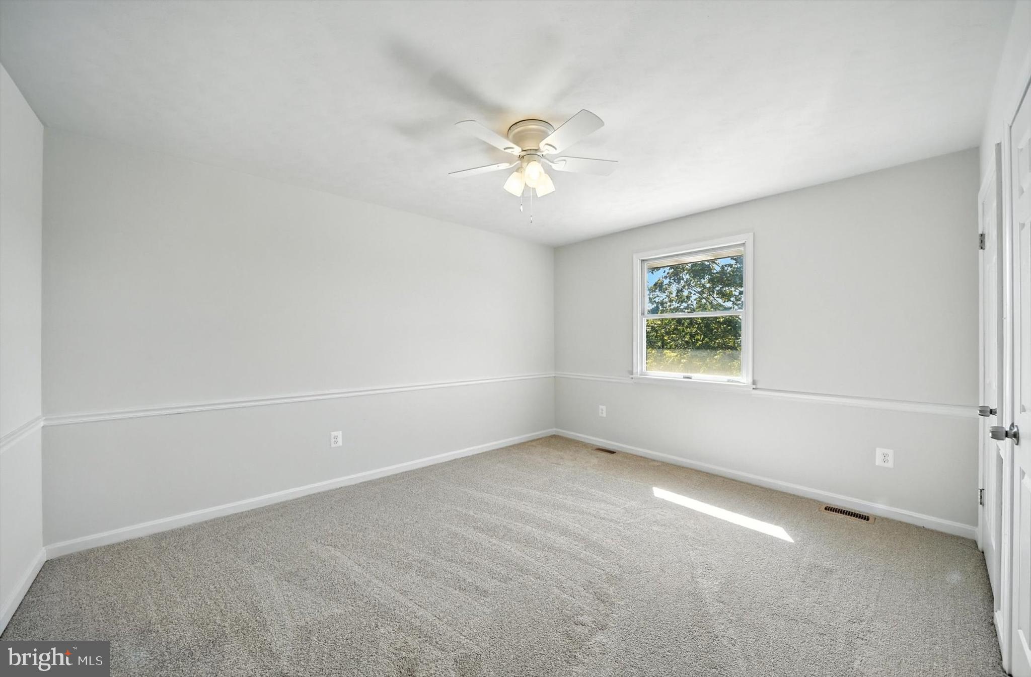 1485 Bachmans Valley Road Westminster, MD 21158 - Photo 33 of 60 an empty room with a window and a fan