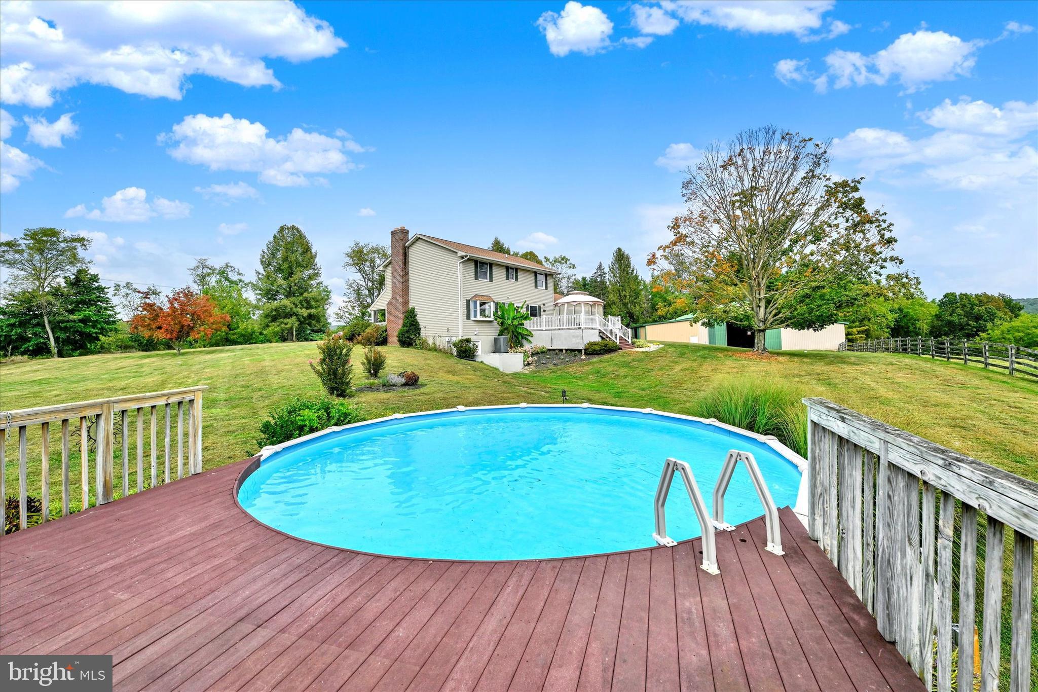 1485 Bachmans Valley Road Westminster, MD 21158 - Photo 48 of 60 a view of a swimming pool with a garden and deck