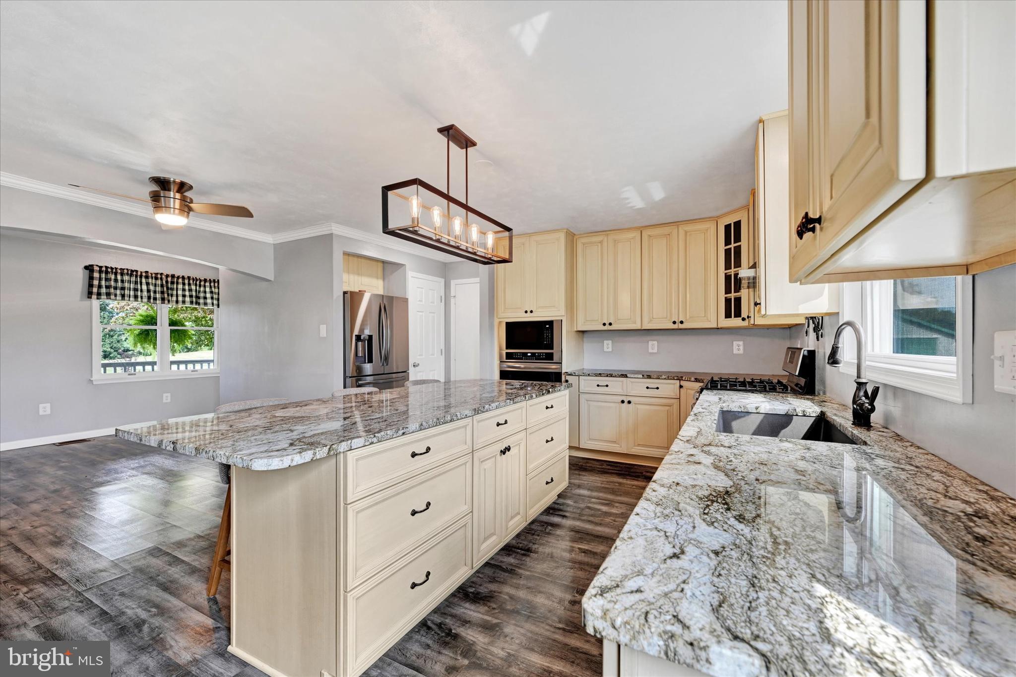1485 Bachmans Valley Road Westminster, MD 21158 - Photo 6 of 60 a large kitchen with kitchen island granite countertop a sink and cabinets