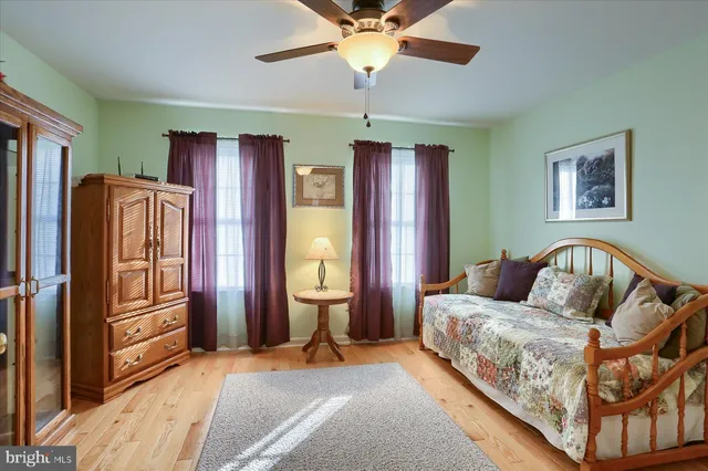 a bedroom with a bed dresser and a window