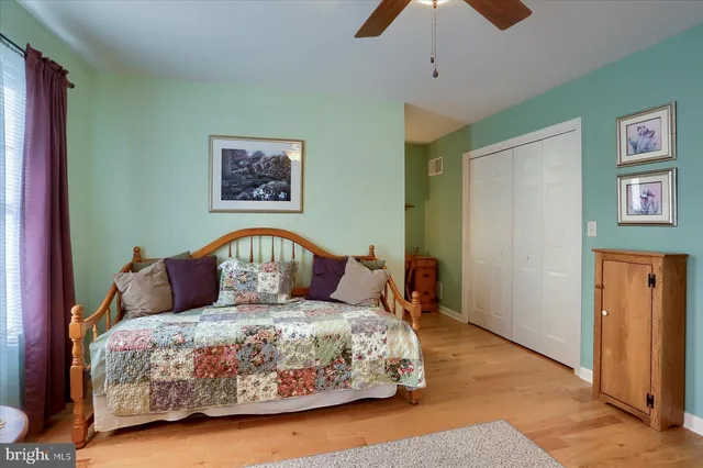 a large bed sitting in a bedroom next to a window