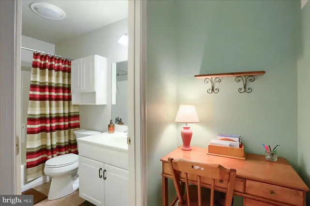 a bedroom with a bed and a dresser in it