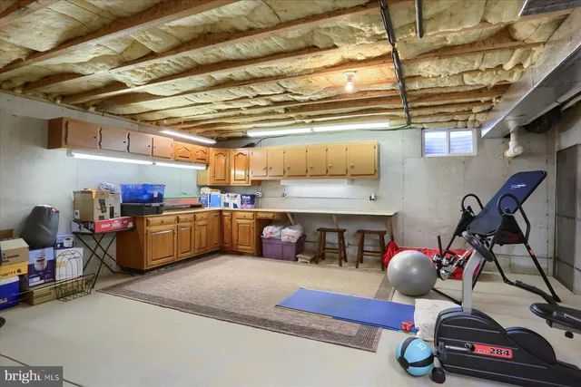 a living room with lots of furniture and clutter