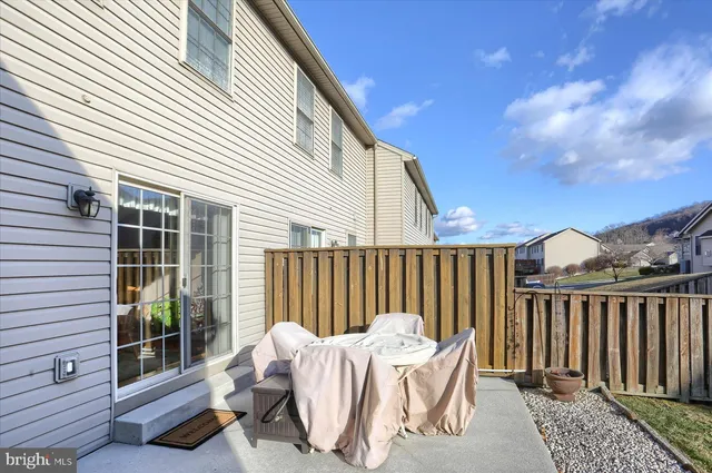 a view of balcony with two chairs and wooden fence