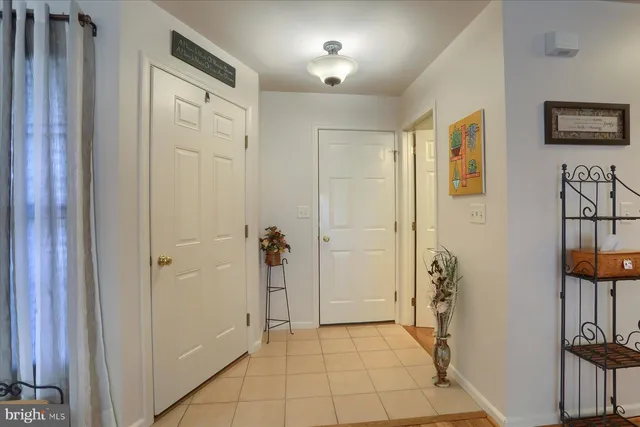 a view of a hallway with closet and a door