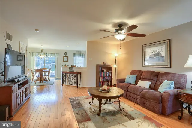 a living room with furniture a dining table and a piano