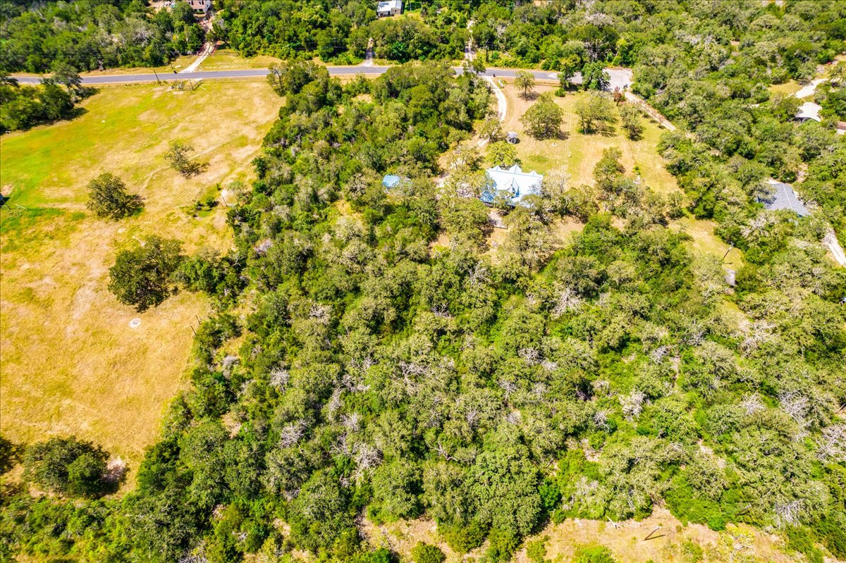 19106 Eyerley Road Manor, TX 78653 - Photo 33 of 40 An aerial perspective reveals a vast, tree-filled landscape with scattered clearings and a distant residential structure.