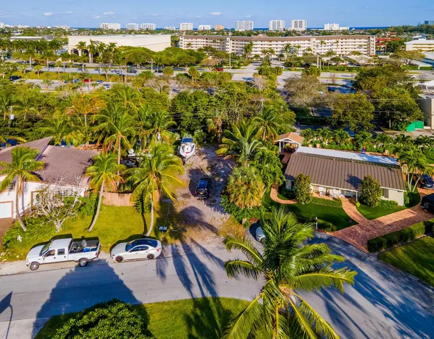 an aerial view of residential houses with outdoor space and street view