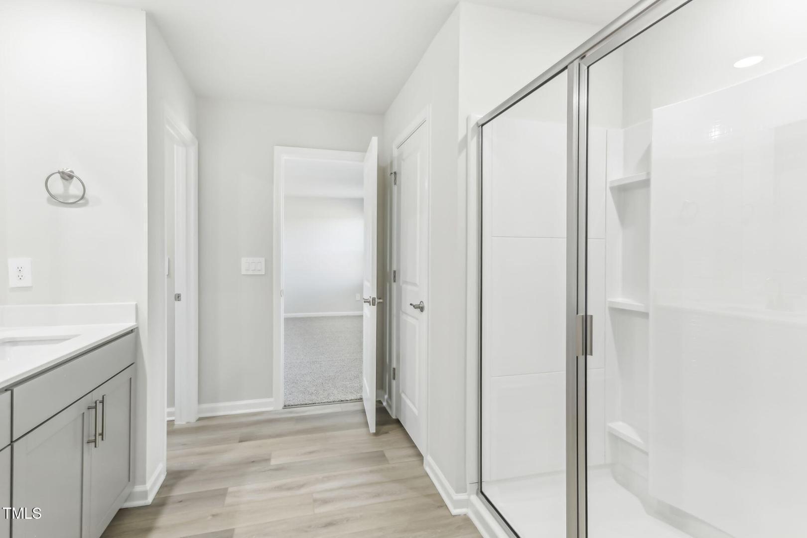 191 White Birch Lane Angier, NC 27501 - Photo 15 of 35 a view of a kitchen with white cabinets and wooden floor