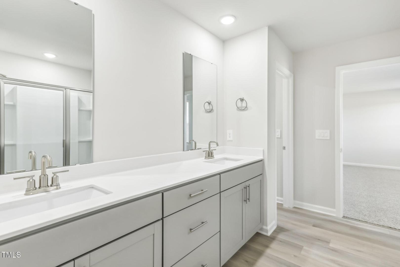 191 White Birch Lane Angier, NC 27501 - Photo 16 of 35 a bathroom with double sink and a mirror