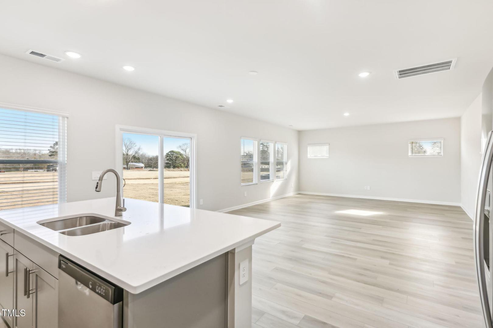191 White Birch Lane Angier, NC 27501 - Photo 28 of 35 a kitchen with stainless steel appliances a sink and a large window