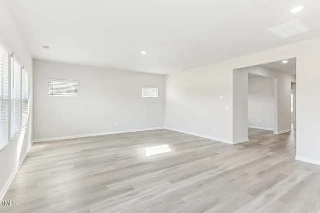 a view of a kitchen with a sink and wooden floor