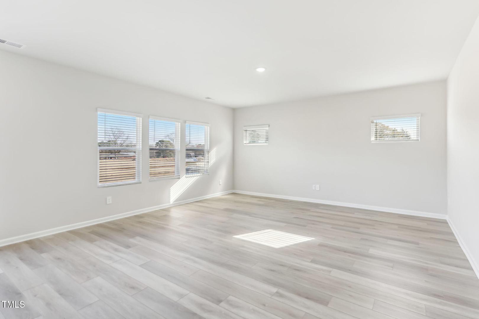 191 White Birch Lane Angier, NC 27501 - Photo 33 of 35 a view of an empty room with wooden floor and a window