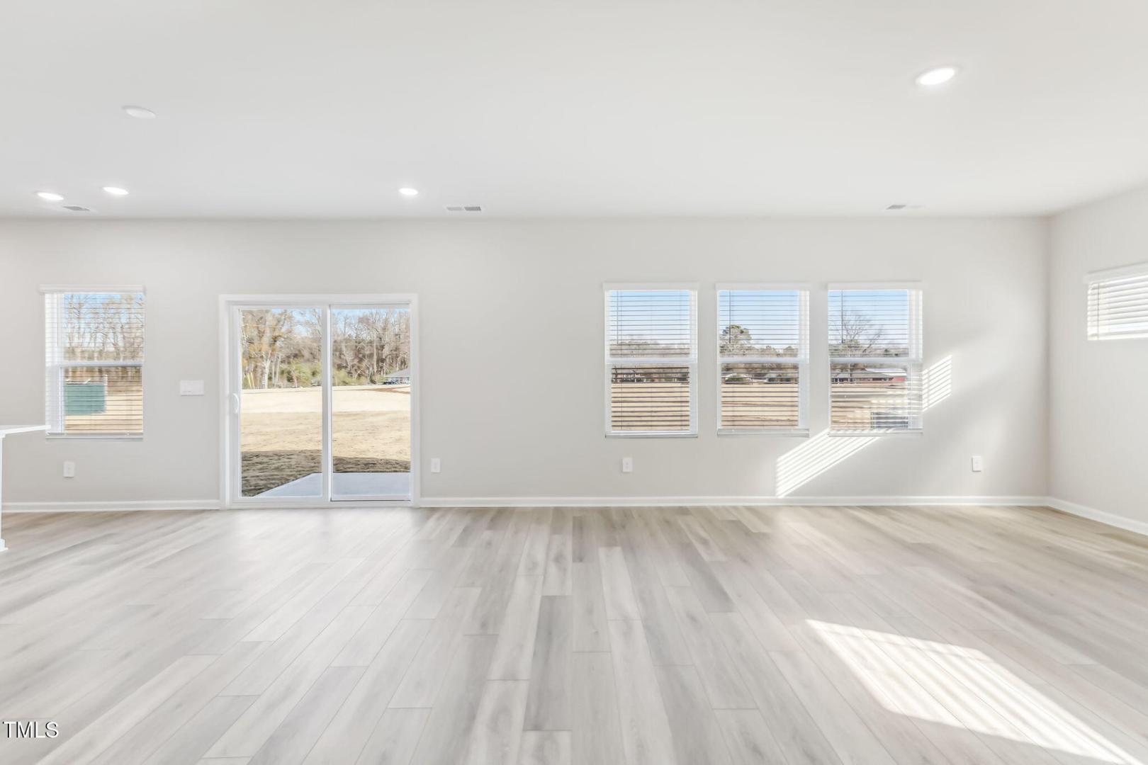 191 White Birch Lane Angier, NC 27501 - Photo 34 of 35 a view of empty room with wooden floor and fan
