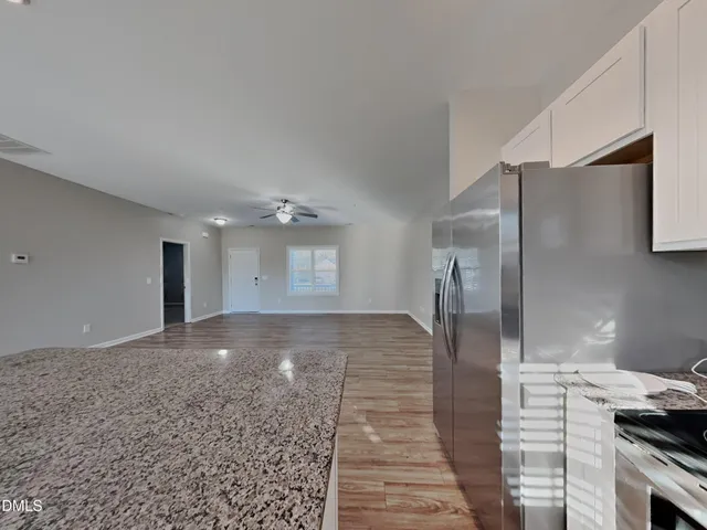 a view of a refrigerator in kitchen and wooden floor