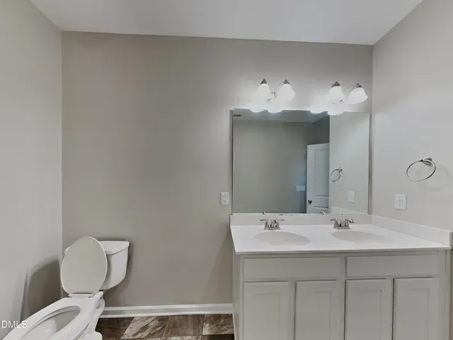 a bathroom with a sink vanity and a mirror