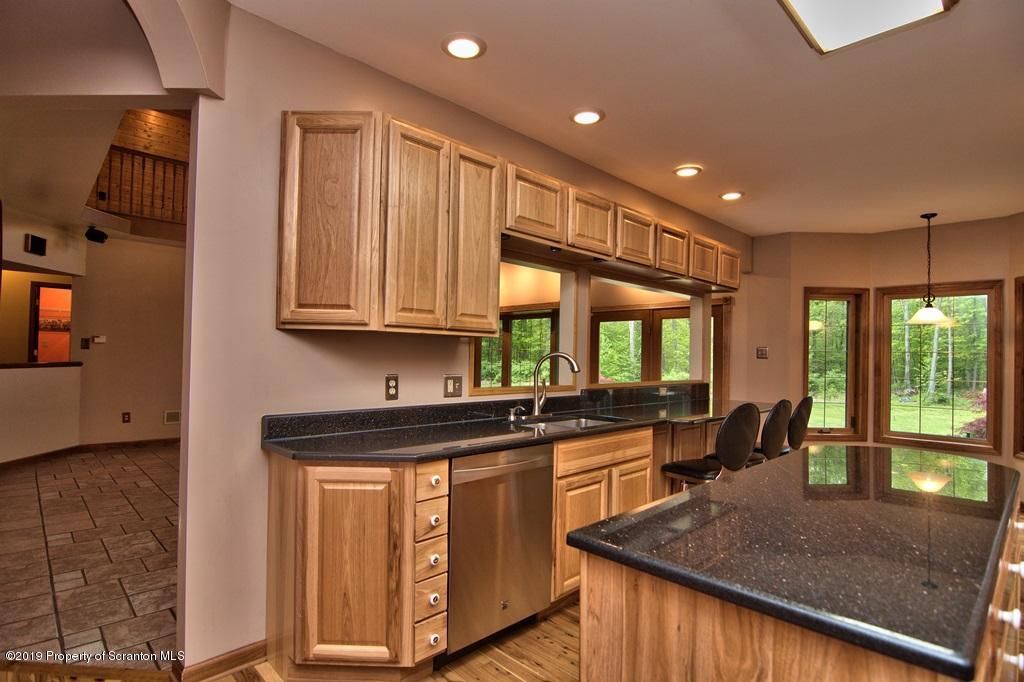 16 Pine Ridge Road Tunkhannock, PA 18657 - Photo 24 of 86 a kitchen with stainless steel appliances granite countertop sink stove and cabinets