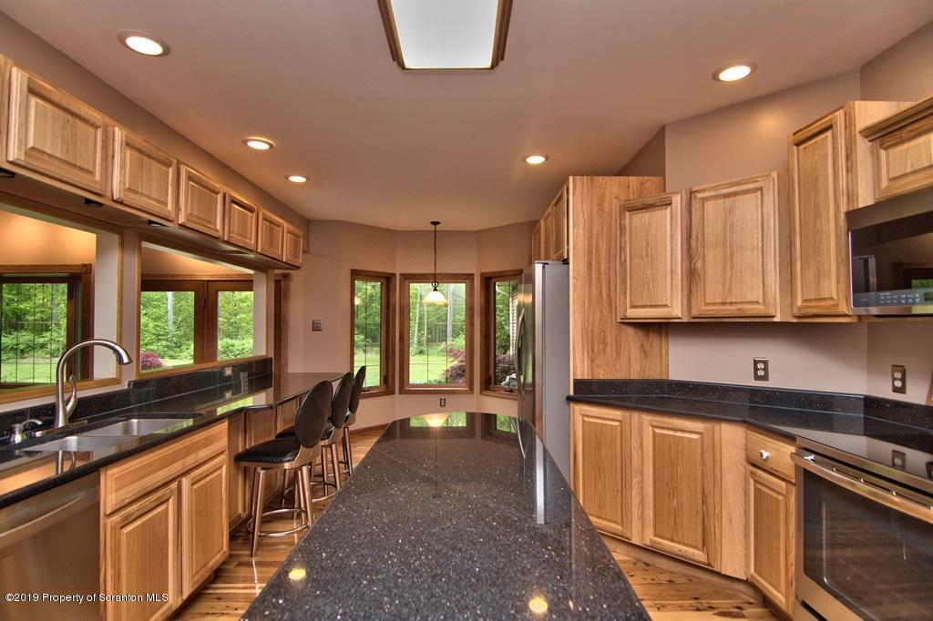 16 Pine Ridge Road Tunkhannock, PA 18657 - Photo 25 of 86 a open kitchen with stainless steel appliances granite countertop a sink stove and cabinets