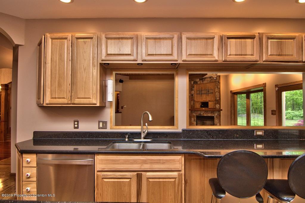 16 Pine Ridge Road Tunkhannock, PA 18657 - Photo 27 of 86 a kitchen with stainless steel appliances granite countertop a sink and cabinets