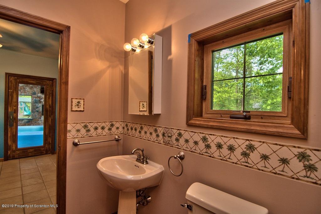 16 Pine Ridge Road Tunkhannock, PA 18657 - Photo 28 of 86 a bathroom with a sink and a mirror