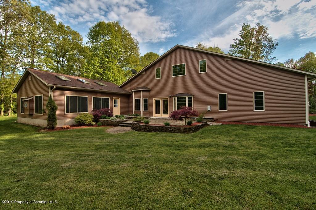 16 Pine Ridge Road Tunkhannock, PA 18657 - Photo 4 of 86 a front view of a house with yard and green space